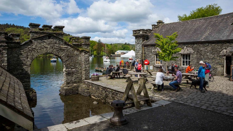 Visitors outside the Boathouse cafe in spring at Fell Foot, Cumbria